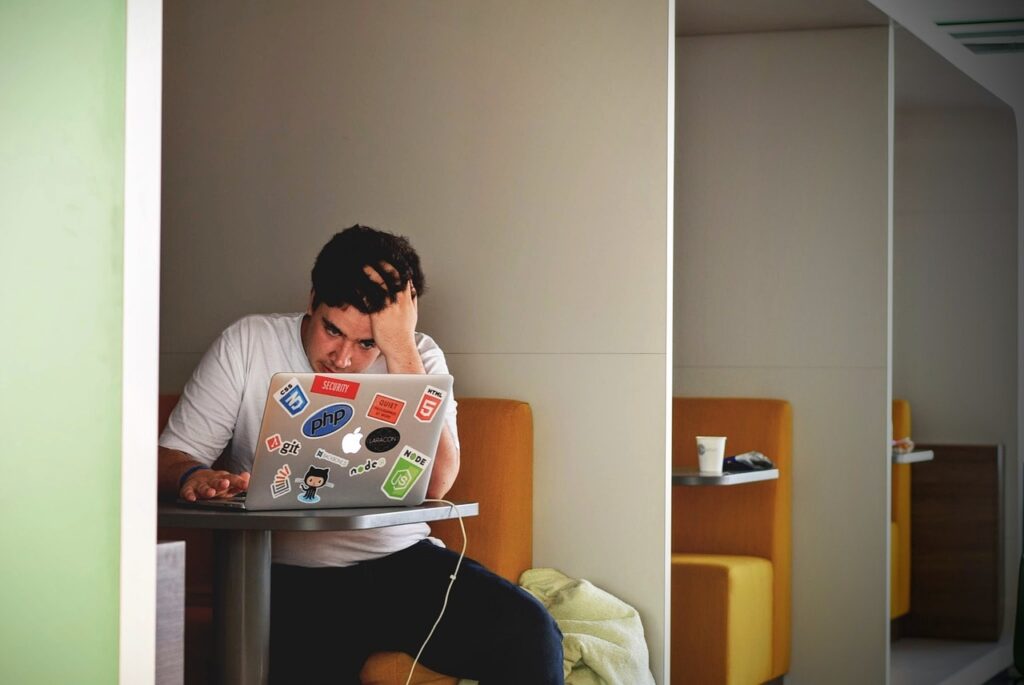 man, boy, laptop, cafe, frustrated, frustration, yound, expression, emotions, alone, booth, table, brown computer, brown laptop, brown alone, brown table, brown cafe, frustrated, frustrated, frustrated, frustrated, frustrated, frustration, frustration, frustration