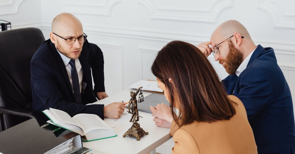 Lawyer consulting clients in a modern office setting, serious discussion.