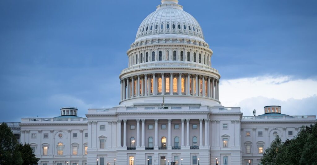 The iconic United States Capitol Building illuminated against a twilight sky.